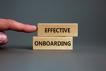 Effective onboarding symbol. Wooden blocks with words Effective onboarding on beautiful grey background. Businessman hand. Business, HR and effective onboarding concept. Copy space.