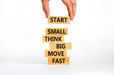 Start small think big symbol. Words 'Start small think big move fast' on wooden blocks on a...