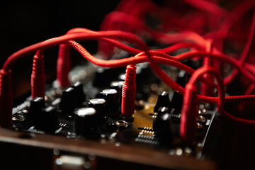 Analog synthesizer with audio cables. Professional modular synth device for electronic music...