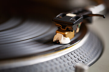 Turntables needle on vinyl record. Dj turn table device playing records with music. Professional...