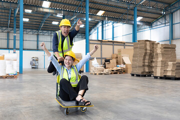 factory workers moving cart and funny pose in warehouse storage