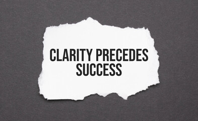 Clarity precedes success sign on the torn paper on the black background