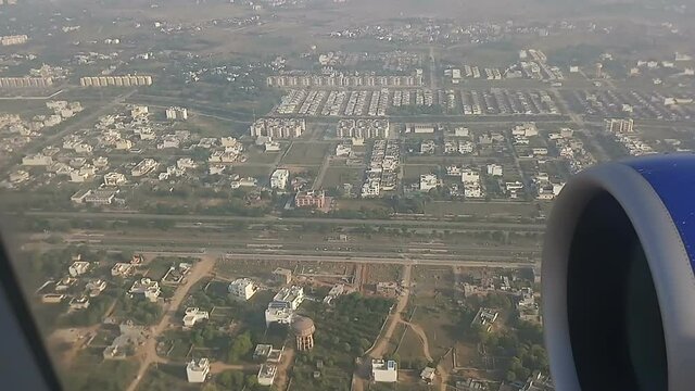 Aeroplane preparing to land into Jaipur city airport. Jaipur, India. City is seen from above.