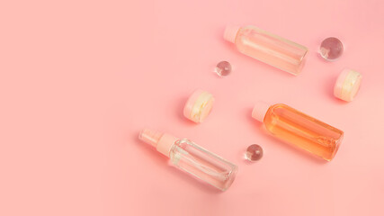 Group of cosmetics bottles with cream and liquid products. Travel kit,flat lay.Pretty pink color,large banner.