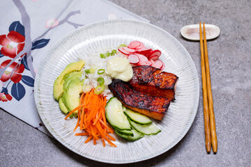 Japanese style meal with grilled salmon, rice and pickled vegetables