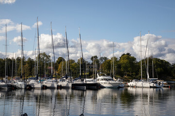 Fototapeta na wymiar Gustavsberg. Boat pier and yachts on a background of blue sky