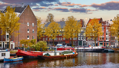Bridge over channel in Amsterdam Netherlands houses river Amstel landmark old european city spring landscape.
