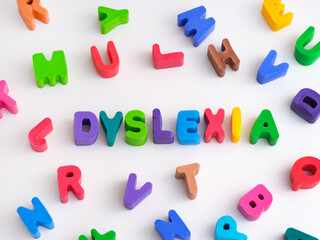 The word Dyslexia made out of play clay letters with other play clay letters surrounding it.