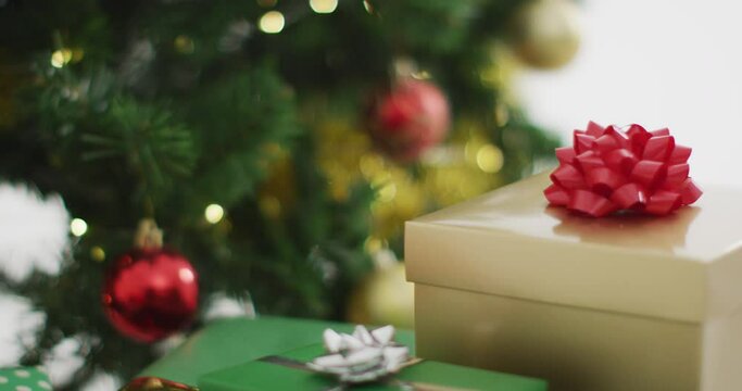 Video of decorated christmas tree with presents on white background