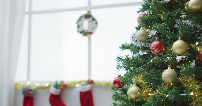 Video of christmas greetings, decorations, christmas tree, lights and christmas stockings at home