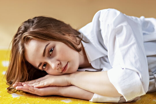 Portrait of a young teenage girl lying on the floor. Stress, depression, relaxation. Mental health