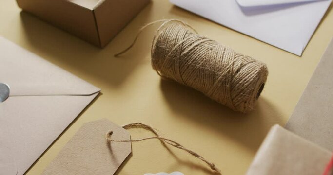 Video of box, envelopes, tags and string on green background