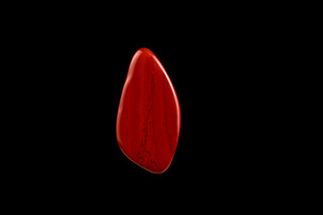 Close-up Red Jasper stone isolated on a black background.