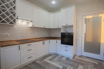 Modern kitchen in light colors in a residential building