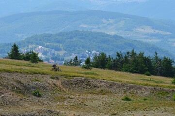 a man rides a motorcycle on the mountains