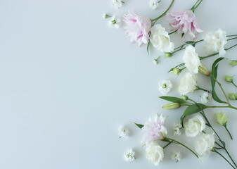 White and pink flowers frame on blue   background top view, copy space. Flowers composition template.Floral card. © irenastar