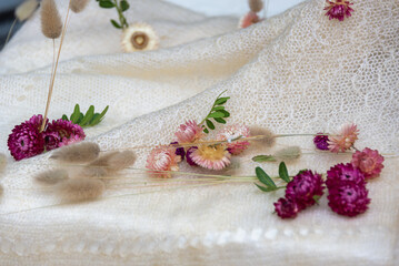 Decorative flowers immortelles on a white cobweb chalet, composition.