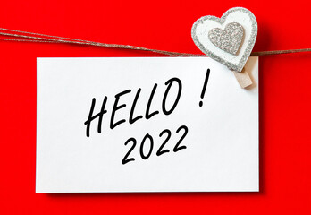 HELLO 2022. background with hearts and card. decorations on red background. concept new year