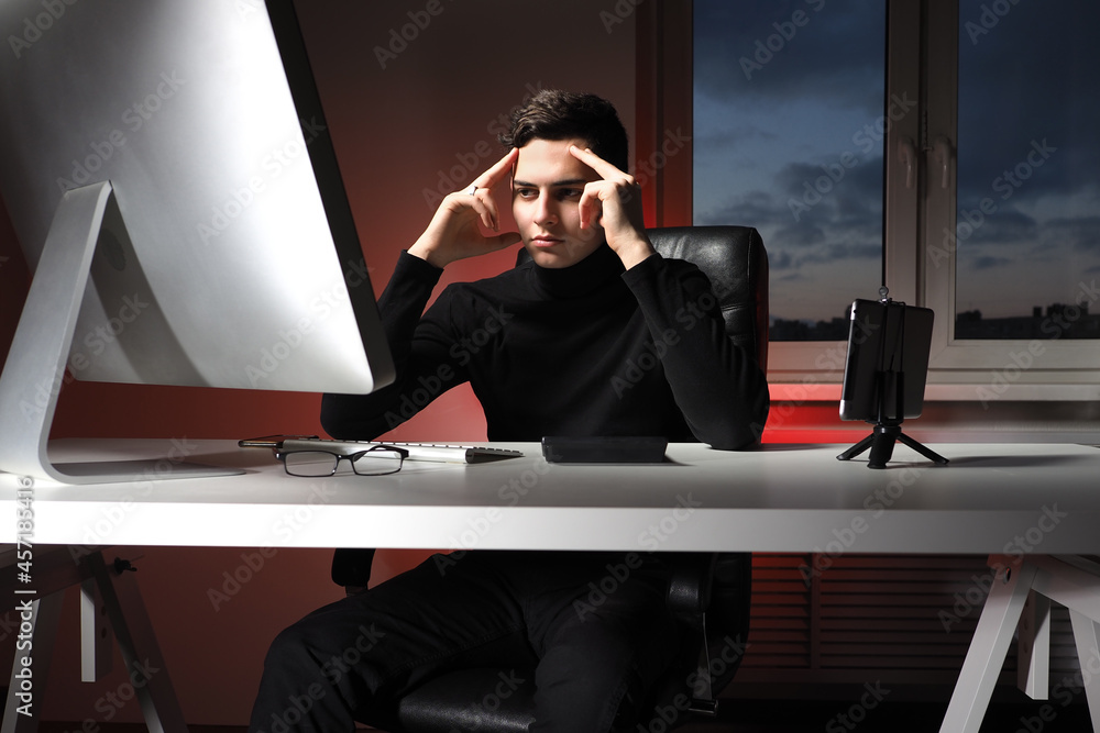 Poster office worker is thinking about something. guy at working table is holding his head. office worker i