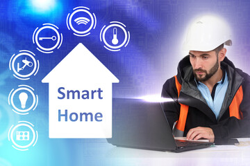 Connecting  smart home system to house. Specialist next to smart home logo. It configures the smart home system. A man with a laptop on a blue background. Remote house control connection.