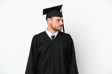 Young university Brazilian graduate isolated on white background looking to the side