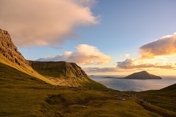 sunset over rolling hills of green.