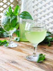 Glass of lemonade made from green basil and lemon - 457186092