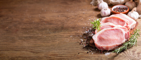 Fresh meat. Pork chops with rosemary and spices on a cutting board