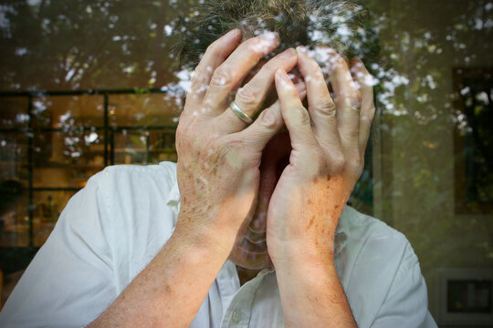 Caucasian Man Holding His Head In His Hands