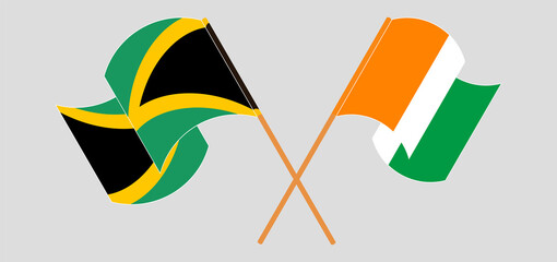 Crossed and waving flags of Jamaica and Republic of Ivory Coast