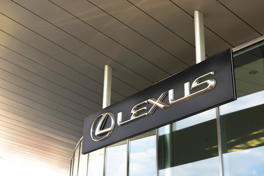Lexus brand logo on dealership building background, emblem, symbol close-up