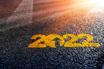 tyre trail track trace motivational writing 2022 on asphalt as a metaphor for moving forward in happy new year