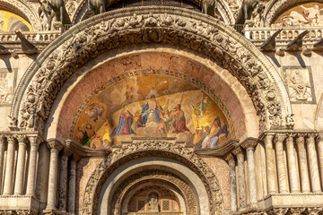 Fototapeta premium Fresco mosaic on the entrance facade of St. Mark's Basilica at St. Marks Square in Venice