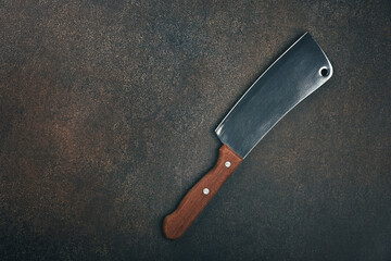 Meat cleaver with wooden handle on table