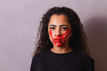 Afro woman with handprint on her mouth in favor of awareness of feminicide. Domestic violence