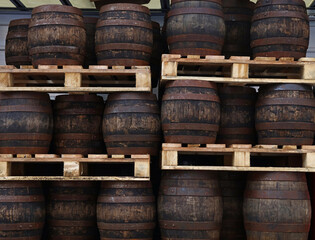 Pallets with vintage oak barrels of craft beer