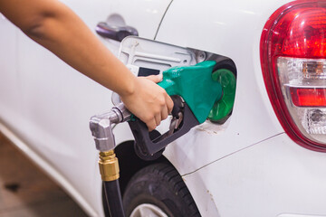 Refueling Car fill with petrol gasoline at gas station and Petrol pump filling fuel nozzle in fuel...