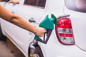 Refueling Car fill with petrol gasoline at gas station and Petrol pump filling fuel nozzle in fuel...