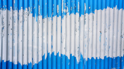Corrugated tin sheet with blue and white shabby paint exterior