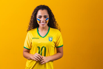 Brazilian supporter. Brazilian woman fan celebrating on soccer or football match on yellow...