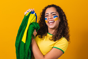 brazilian fan with her face painted in blue and yellow for the brazil game. Brazilian celebrating...