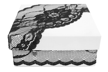 Stylish white gift box, decorated with exquisite black lace ribbon, isolated on white