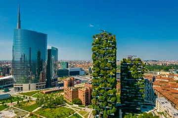 Fotobehang Milaan Aerial view of building called Bosco Verticale in front of office buildings. Vertical Forest, in Milan, Porta Nuova district. Residential buildings with many trees and other plants in balconies