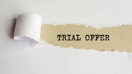 trial offer. words. text on gray paper on torn paper background
