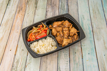 fajita takeout tray fusion chicken in teriyaki sauce with white rice and strips of stewed onions and peppers