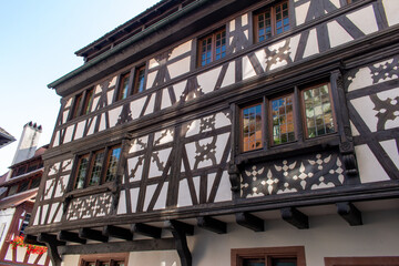 Upward exterior view of traditional German half-timber framed building architecture in Strasbourg, France