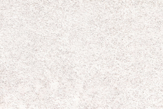 The mottled surface of the granite slab is finely speckled. Uniform texture of natural stone.