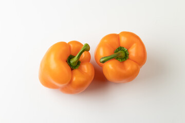 Two orange bell peppers isolated on white background, top view