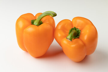 Two orange bell peppers isolated on white background