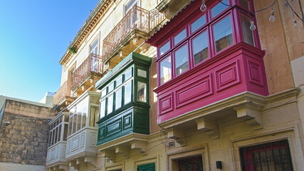 Fototapeta na wymiar Colorful balconies in one of Malta streets. 
